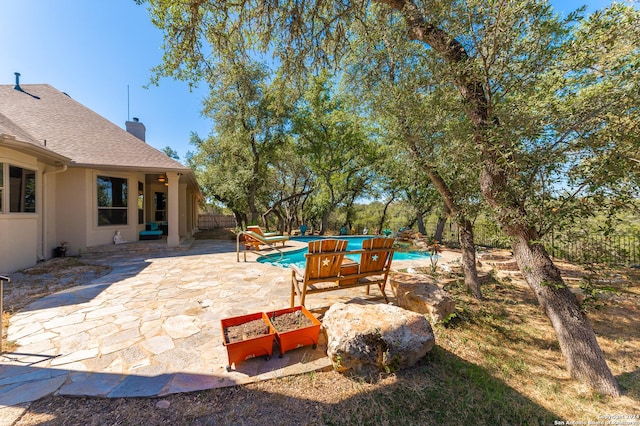 view of patio / terrace with fence and an outdoor pool