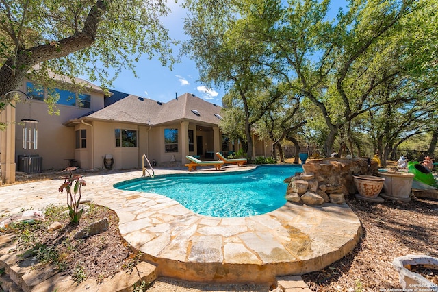 pool featuring central AC unit and a patio