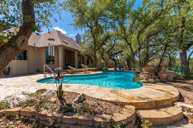 pool with a patio area and fence