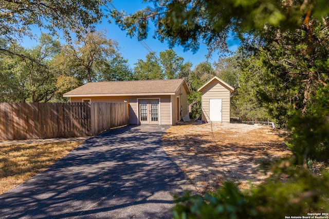 garage with french doors and fence