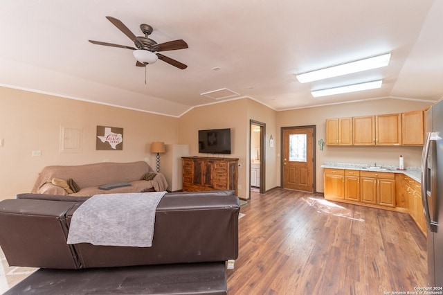 living room featuring ornamental molding, lofted ceiling, ceiling fan, and wood finished floors