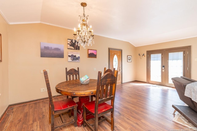 dining space featuring vaulted ceiling, french doors, wood finished floors, and baseboards