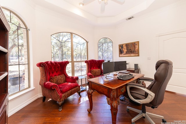 office featuring a tray ceiling, visible vents, a ceiling fan, baseboards, and hardwood / wood-style flooring