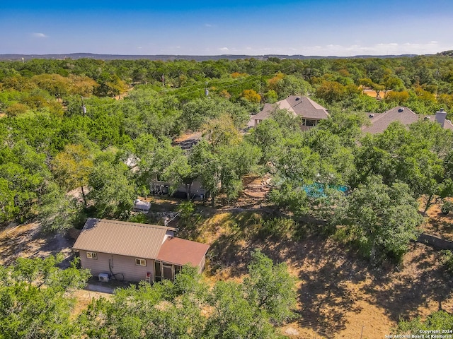 birds eye view of property featuring a view of trees