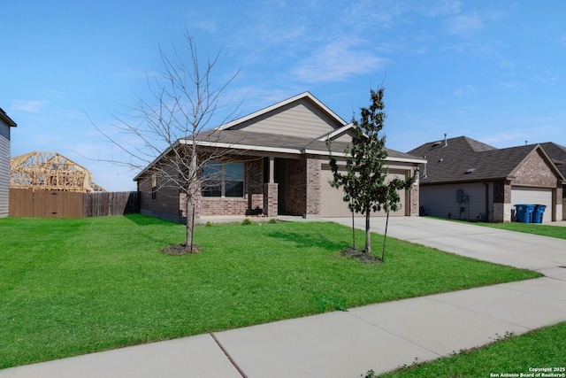 view of front of house featuring brick siding, an attached garage, a front lawn, fence, and driveway