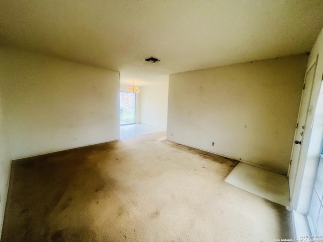 unfurnished room featuring light carpet and visible vents