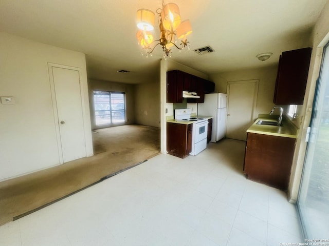 kitchen with white appliances, a sink, visible vents, light countertops, and an inviting chandelier