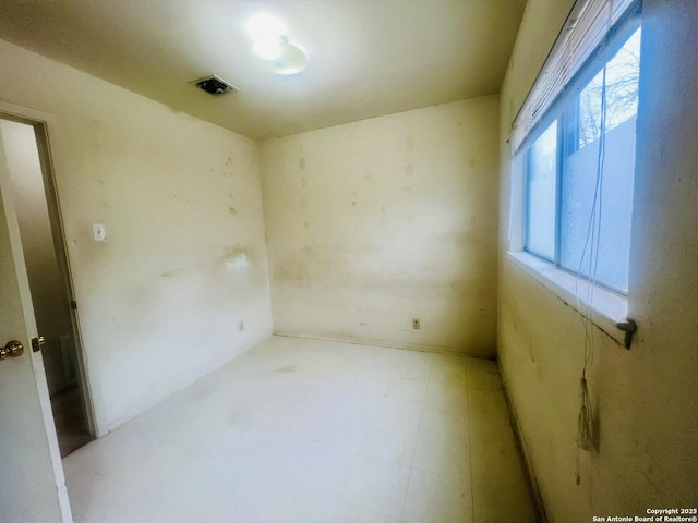 unfurnished room featuring tile patterned floors