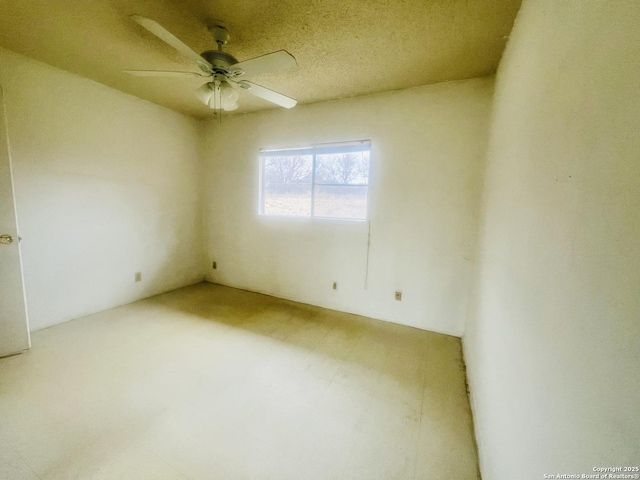 empty room with a ceiling fan and tile patterned floors