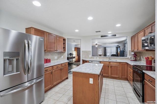 kitchen featuring light tile patterned floors, visible vents, appliances with stainless steel finishes, and open shelves