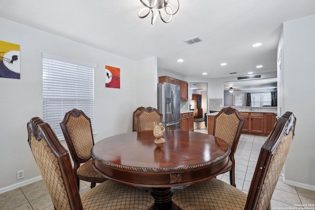 dining area with ceiling fan, visible vents, baseboards, and light tile patterned flooring