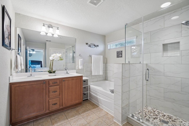 bathroom with a bath, double vanity, a sink, and visible vents