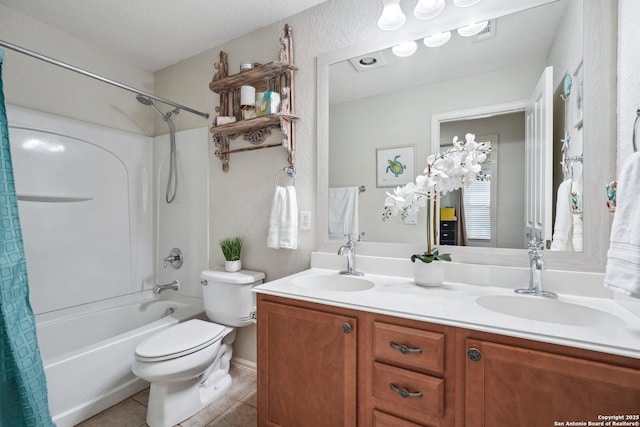 bathroom featuring double vanity, a sink, toilet, and tile patterned floors