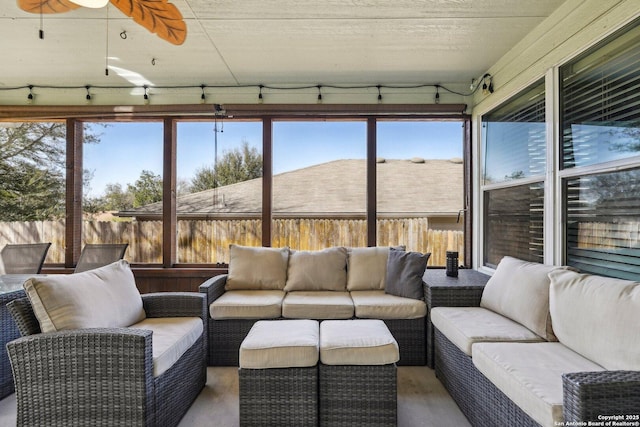 sunroom / solarium with a ceiling fan