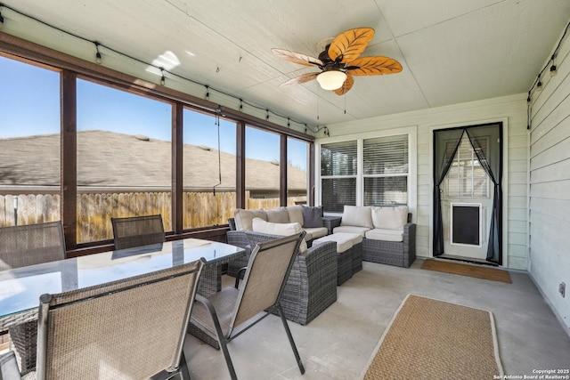 sunroom featuring ceiling fan