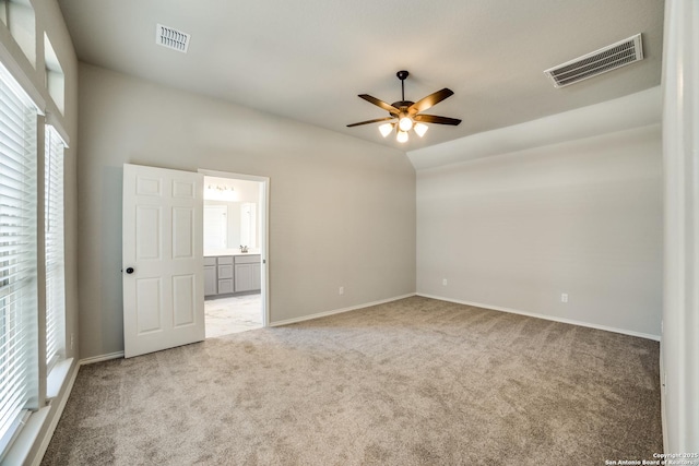 unfurnished bedroom featuring visible vents, carpet floors, baseboards, and ensuite bathroom