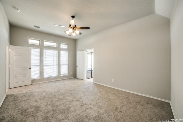 unfurnished room with a ceiling fan, carpet, visible vents, and baseboards