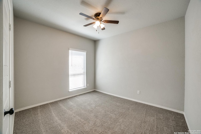 carpeted empty room featuring baseboards and ceiling fan