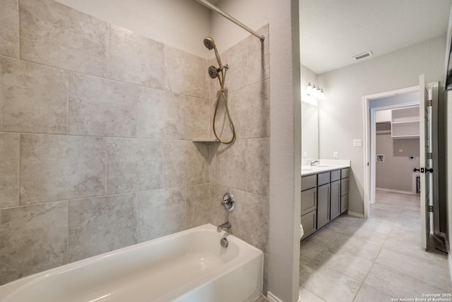 bathroom with vanity, visible vents, baseboards, bathtub / shower combination, and tile patterned flooring