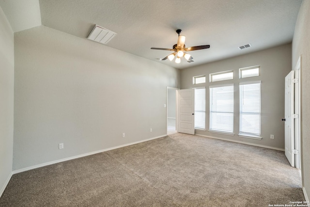 empty room featuring visible vents, baseboards, a ceiling fan, and carpet floors