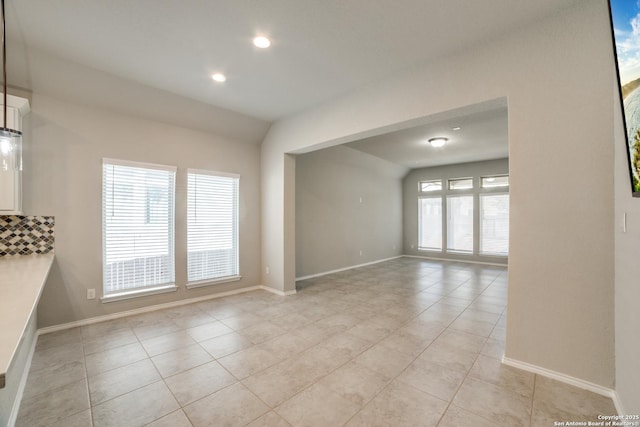 unfurnished room featuring light tile patterned floors, recessed lighting, and baseboards