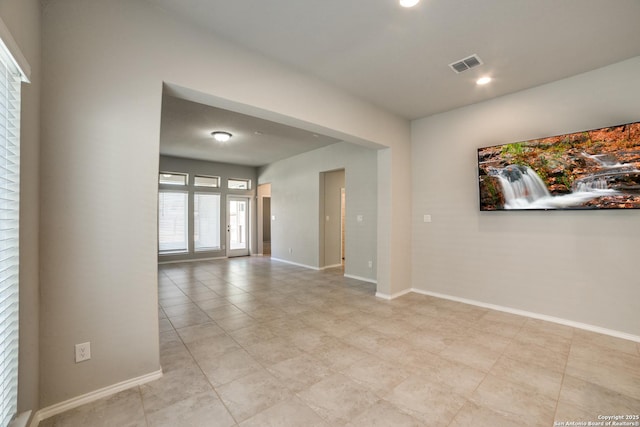 spare room featuring visible vents and baseboards