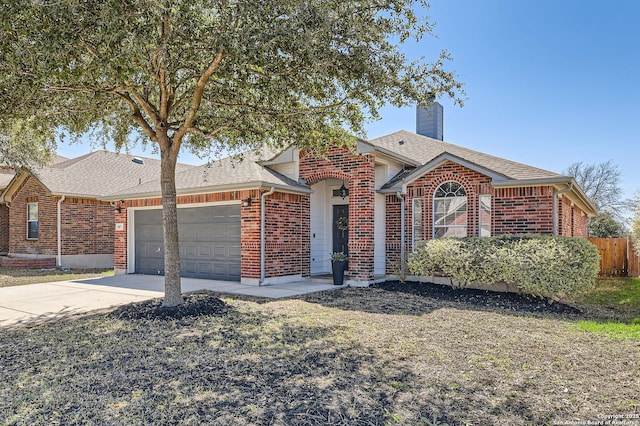 view of front of property featuring brick siding, roof with shingles, a chimney, an attached garage, and driveway