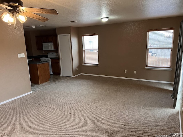 unfurnished living room featuring ceiling fan, a textured ceiling, light carpet, visible vents, and baseboards