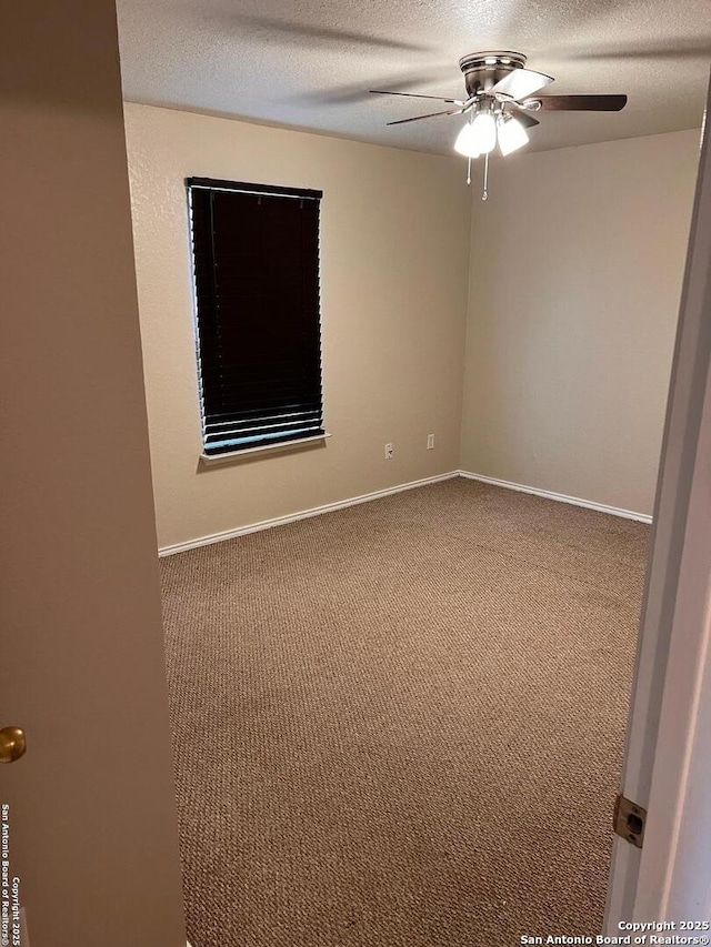 unfurnished room featuring a ceiling fan, carpet, a textured ceiling, and baseboards