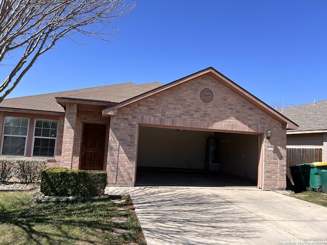 ranch-style house featuring a garage, brick siding, and driveway