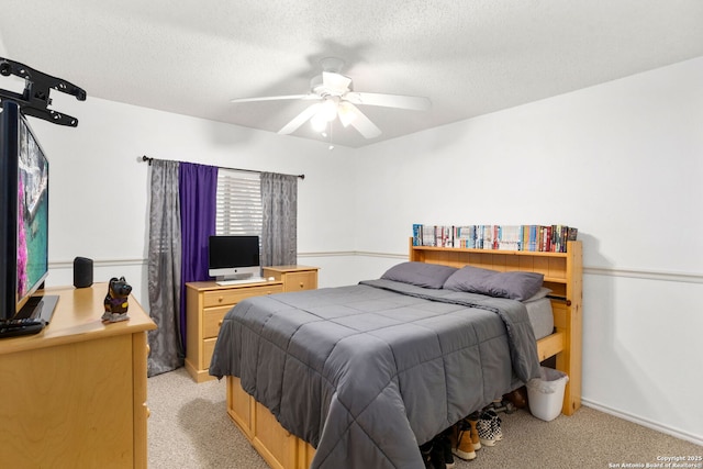 bedroom with light carpet, ceiling fan, and a textured ceiling