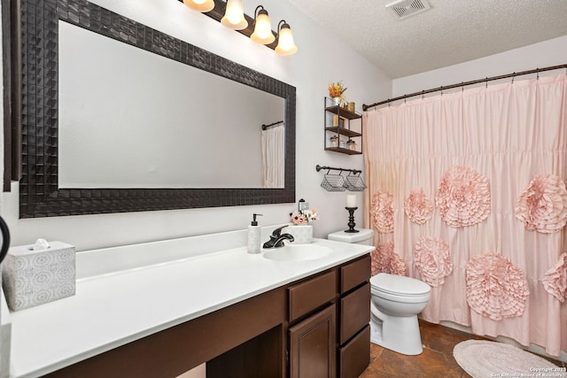 full bathroom with visible vents, toilet, a shower with curtain, a textured ceiling, and vanity