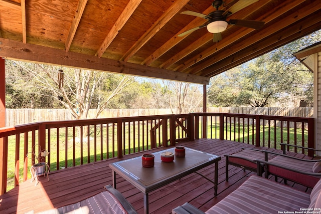 wooden deck featuring a lawn, a fenced backyard, and a ceiling fan