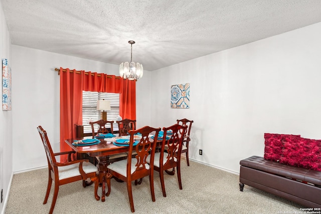 dining space with light carpet, baseboards, a chandelier, and a textured ceiling