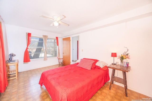 bedroom featuring ceiling fan, baseboards, and tile patterned floors