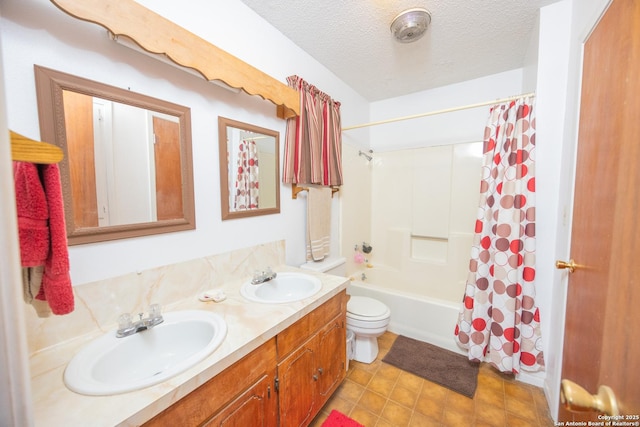 full bath featuring shower / bath combo with shower curtain, a sink, a textured ceiling, and double vanity