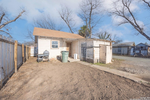 rear view of house with fence