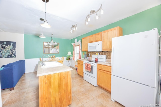 kitchen featuring white appliances, a center island with sink, light countertops, light brown cabinetry, and a sink