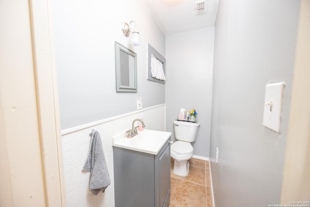 bathroom with toilet, vanity, visible vents, and tile patterned floors