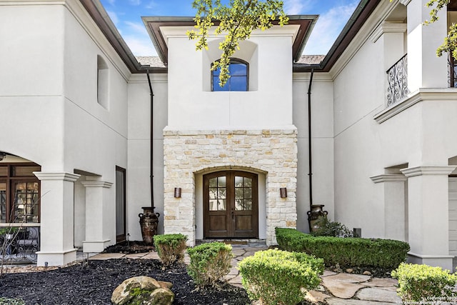 property entrance with stone siding and stucco siding