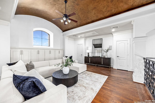 living area featuring dark wood-style floors, decorative columns, visible vents, vaulted ceiling, and ceiling fan