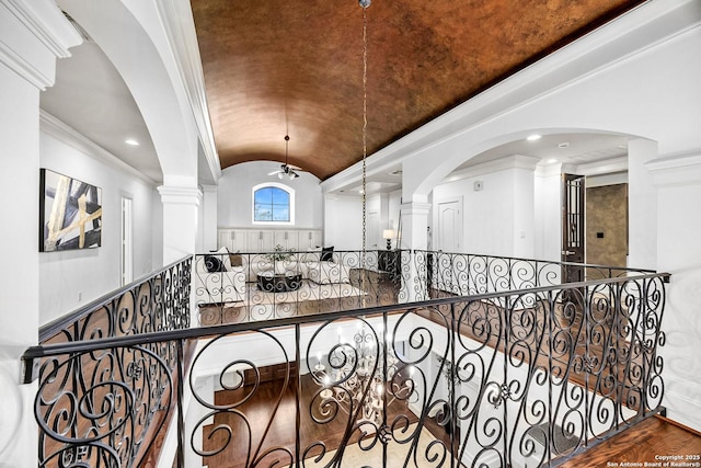 hall with ornamental molding, vaulted ceiling, wood finished floors, and recessed lighting