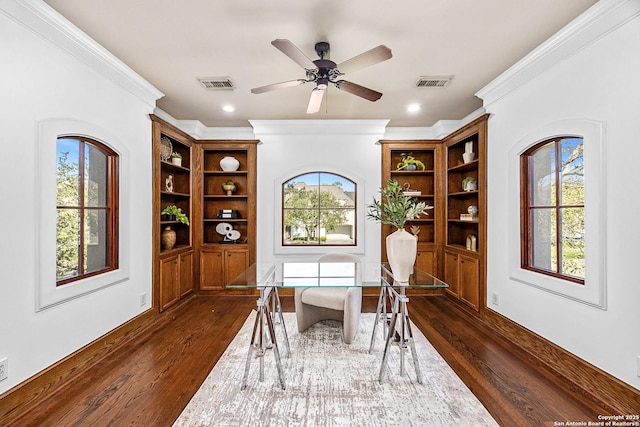 home office with dark wood-style floors, visible vents, and a wealth of natural light