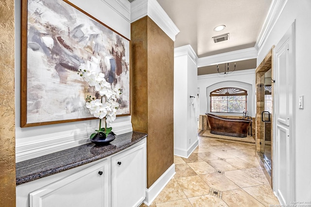 bathroom featuring visible vents, ornamental molding, a shower stall, baseboards, and tile patterned floors