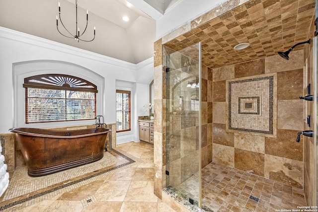 full bathroom with a chandelier, a freestanding tub, a shower stall, and crown molding