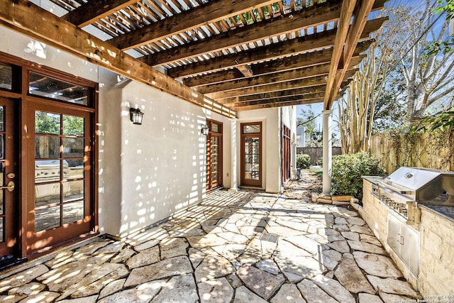 view of patio with area for grilling, grilling area, fence, and a pergola