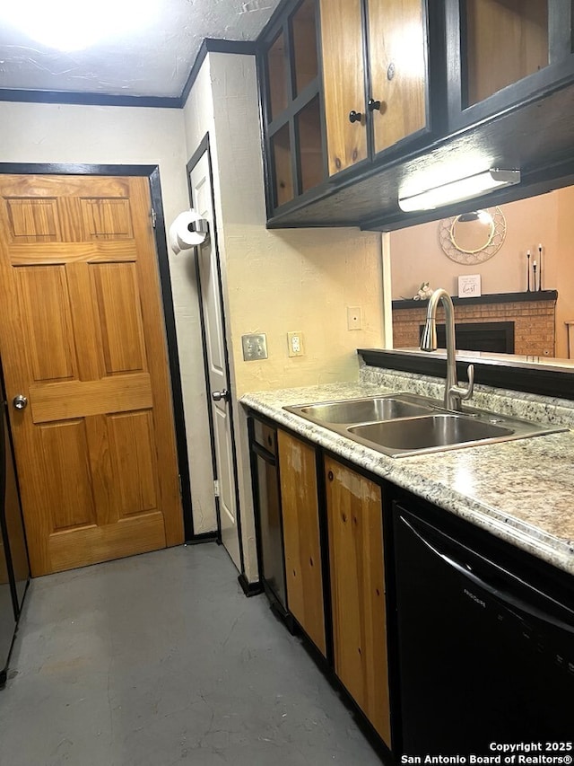 kitchen featuring dishwasher, light countertops, a sink, and finished concrete flooring