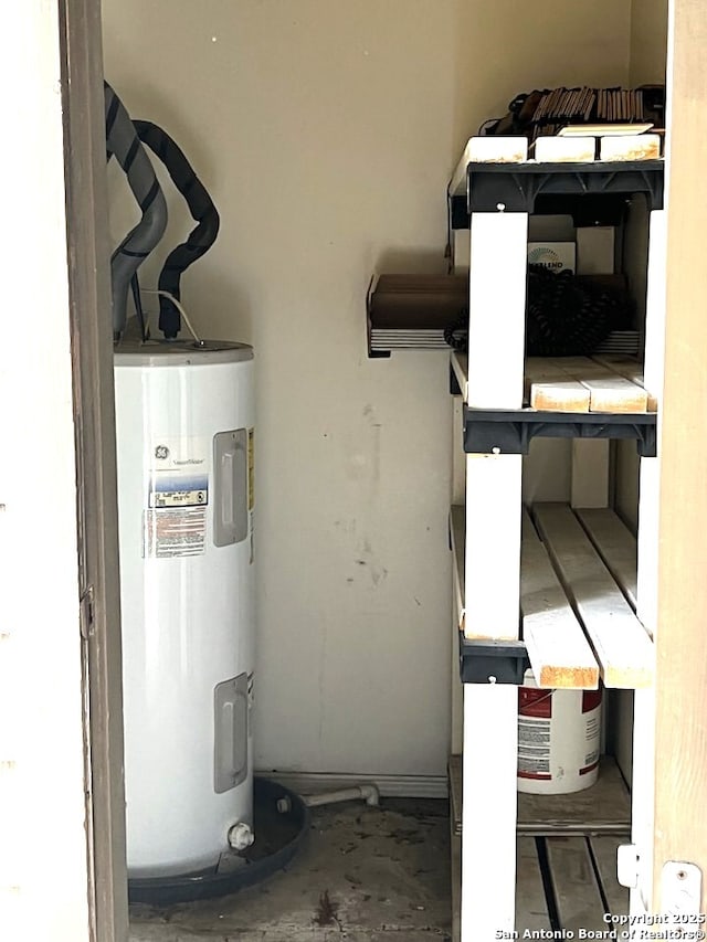 utility room featuring electric water heater