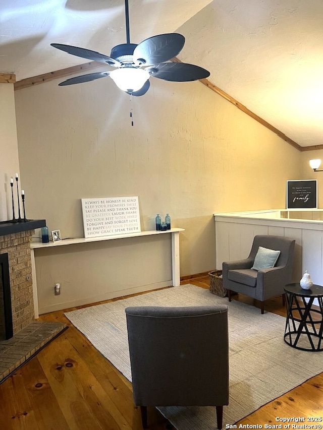 interior space with a brick fireplace and a ceiling fan