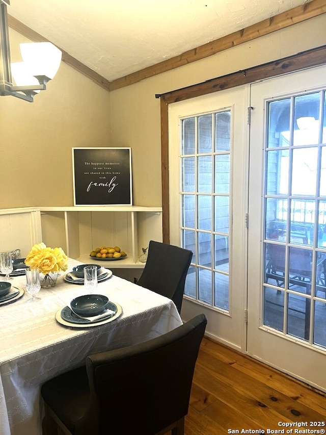 dining room featuring dark wood finished floors and crown molding